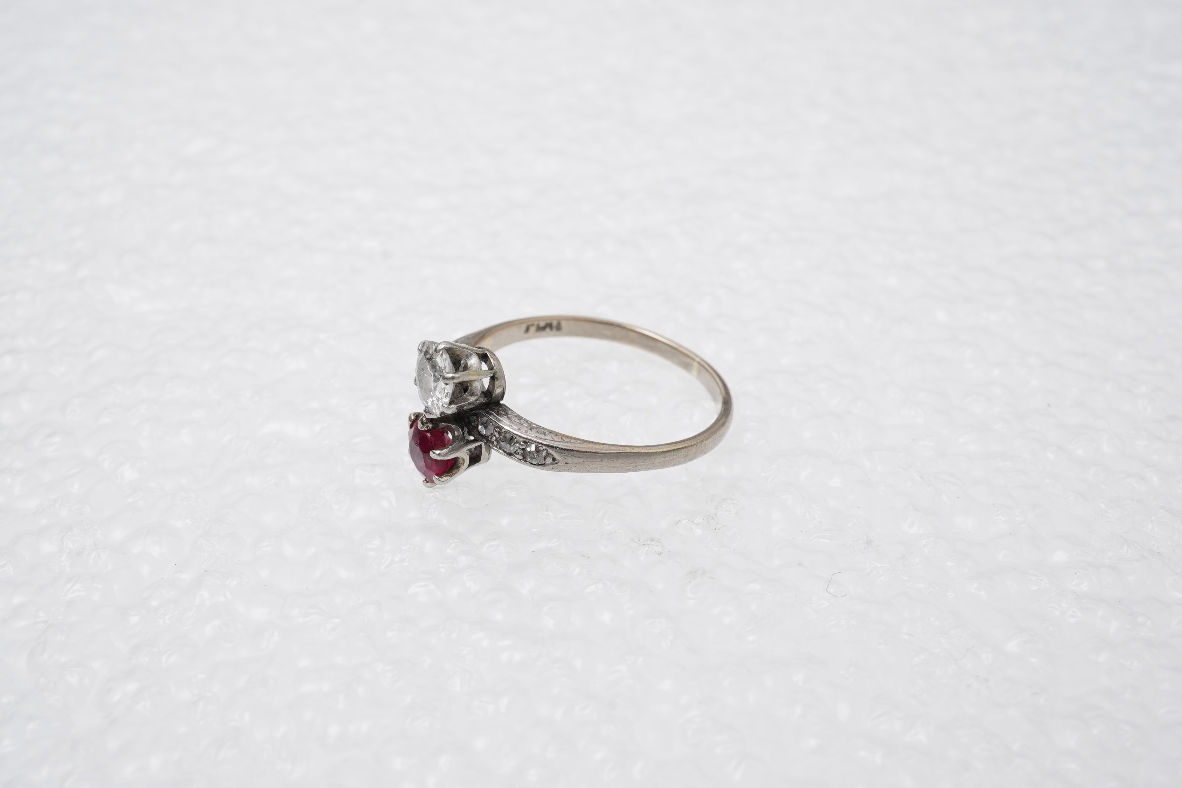 A synthetic ruby and diamond 'toi-et-moi' ring, early 20th century